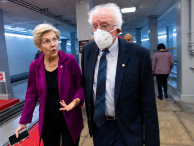 Sen. Elizabeth Warren (D-Massachusetts) and Sen. Bernie Sanders (I-Vermont), walk through the Senate subway on their way to a vote in the Capitol on Thursday, September 22, 2022.