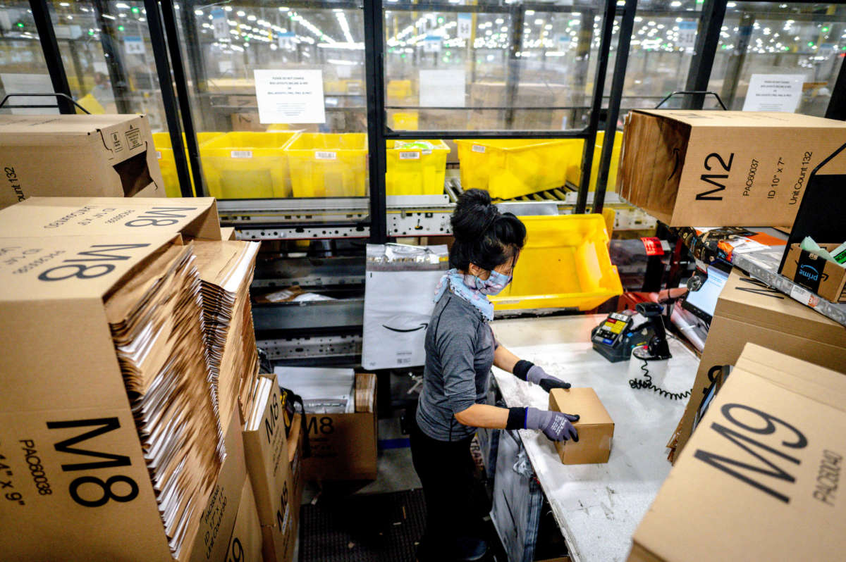 A worker packs items at Amazon fulfillment center in Eastvale, California, on August 31, 2021.