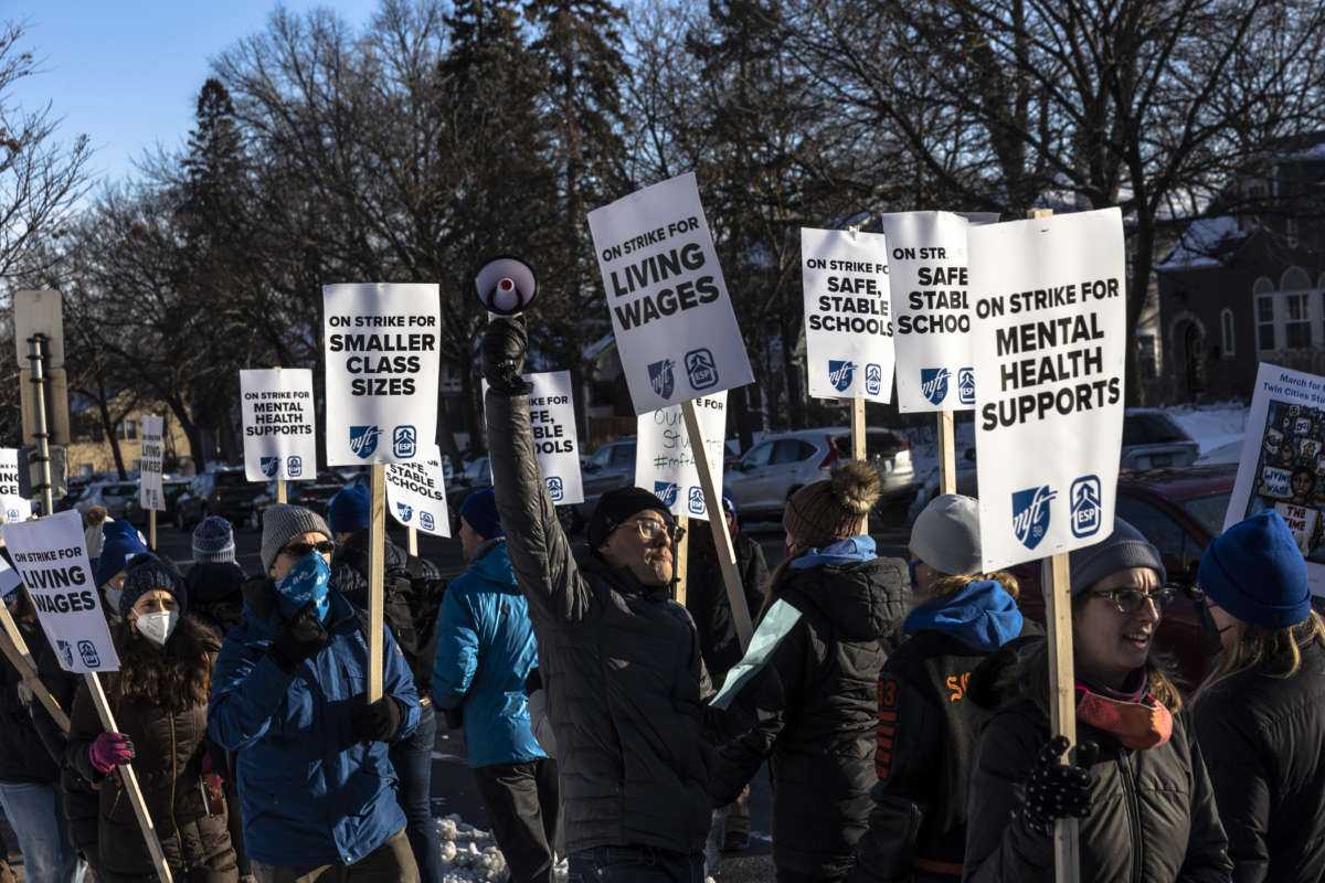 Minneapolis school teachers hold placards during the strike in front of the Justice Page Middle school in Minneapolis, Minnesota, on March 8, 2022.