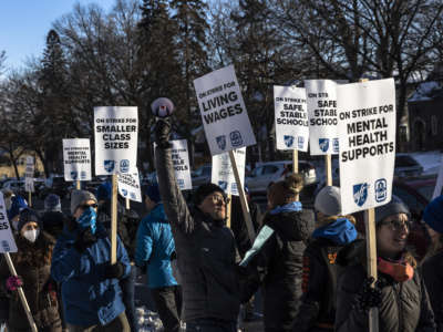 Minneapolis school teachers hold placards during the strike in front of the Justice Page Middle school in Minneapolis, Minnesota, on March 8, 2022.