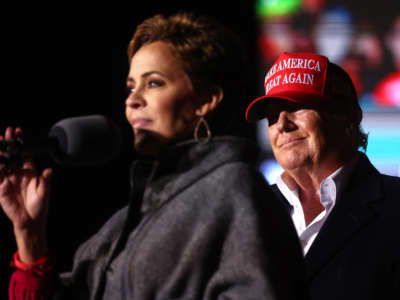 Republican governor candidate for Arizona Kari Lake, left, speaks as former President Donald Trump looks on at a rally at the Canyon Moon Ranch festival grounds on January 15, 2022, in Florence, Arizona.