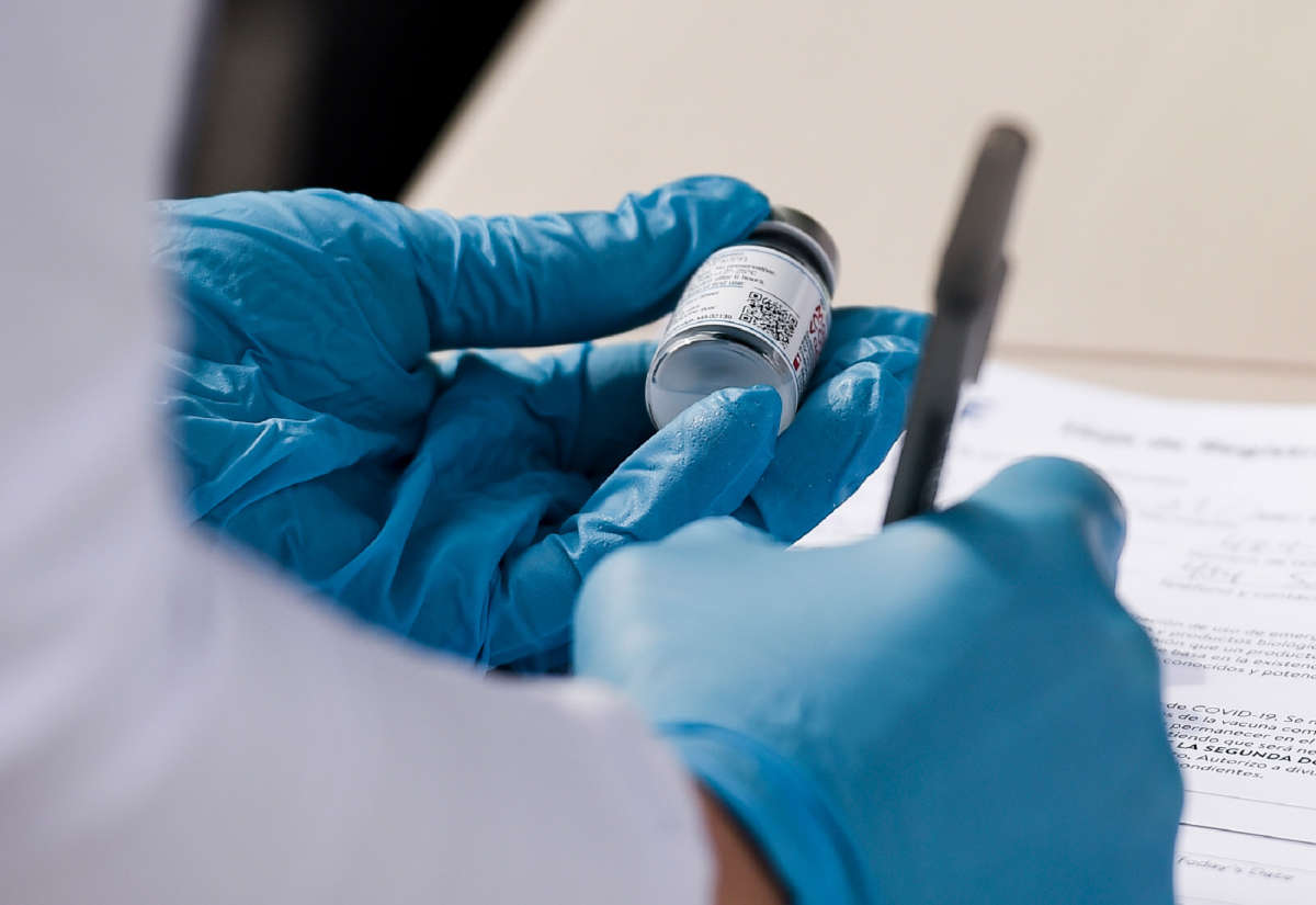 A nurse writes down information from a vial of Moderna COVID-19 vaccine at a mobile vaccine clinic setup in Reading, Pennsylvania, on April 19, 2021.