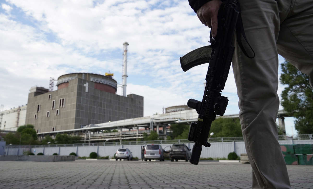 This photo taken on September 11, 2022, shows a security person standing in front of the Zaporizhzhia Nuclear Power Station in Enerhodar, Zaporizhzhia Oblast, amid the ongoing Russian military action in Ukraine.