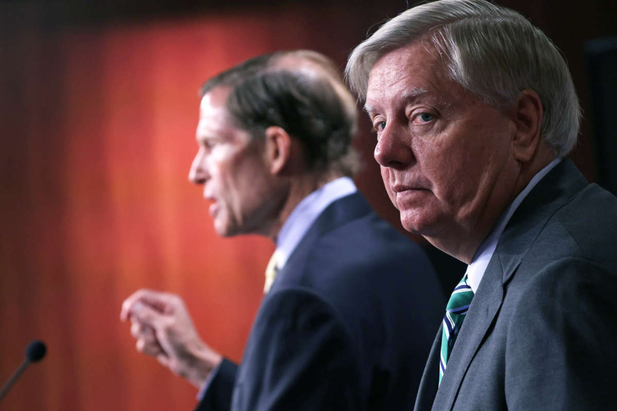 Lindsey Graham looks toward, but not at, the camera, as Richard Blumenthal is seen speaking in profile behind him