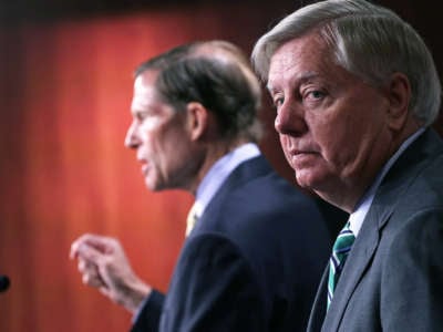 Lindsey Graham looks toward, but not at, the camera, as Richard Blumenthal is seen speaking in profile behind him