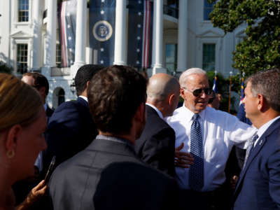 President Joe Biden takes pictures with guests after speaking at an event celebrating the passage of the Inflation Reduction Act on the South Lawn of the White House on September 13, 2022, in Washington, D.C.