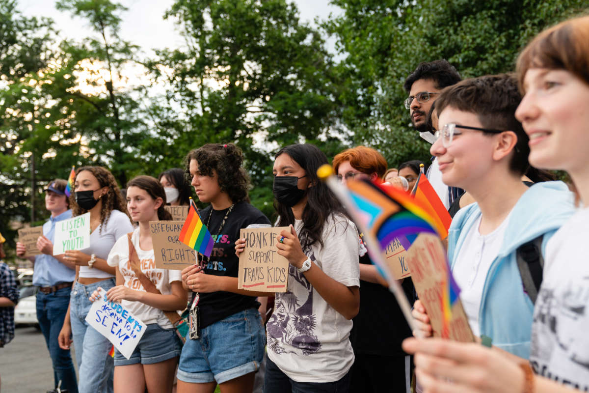 Students listen during a rally in support of inclusive Family Life Education outside of Luther Jackson Middle School in Falls Church, Virginia, on July 14, 2022.