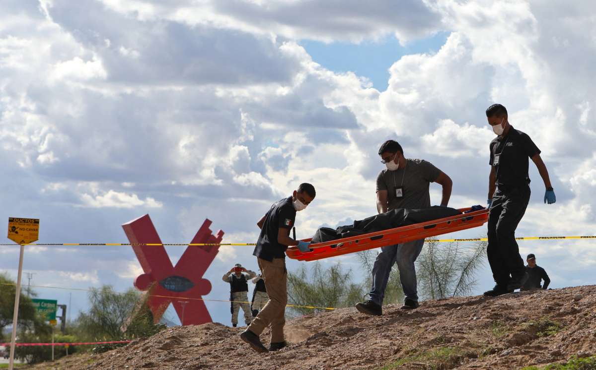 Forensic experts carry the body of a Guatemalan migrant girl who drowned while trying to cross the Rio Grande with her mother into the United States, in Ciudad Juarez, state of Chihuahua, Mexico, on August 22, 2022. The girl's mother was rescued.