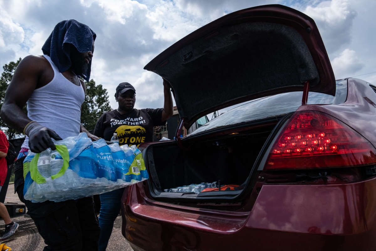 Residents distribute cases of water at Grove Park Community Center in Jackson, Mississippi, on September 3, 2022.