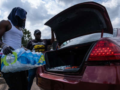 Residents distribute cases of water at Grove Park Community Center in Jackson, Mississippi, on September 3, 2022.