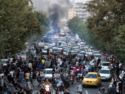Dozens of people stage a demonstration to protest the death of Mahsa Amini, a 22-year-old woman, while in custody in Tehran, Iran, on September 21, 2022.