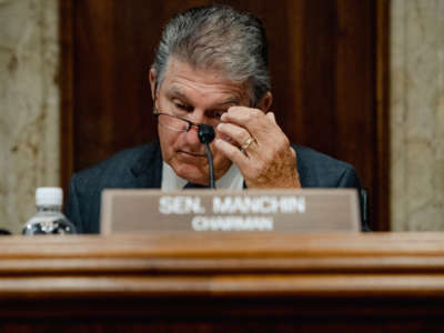 Sen. Joe Manchin, chairman of the Senate Energy and Natural Resources Committee, reads paperwork before holding a hearing on battery technology, at the Dirksen Senate Office Building in Washington, D.C., on September 22, 2022.