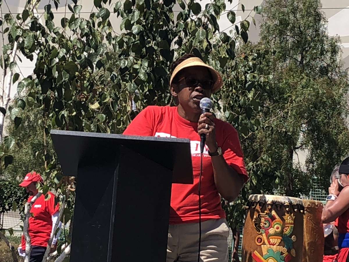 Sabrina Chaumette, a therapist at Kaiser Permanente, speaks during a Labor Day rally outside Kaiser’s Oakland Medical Center.