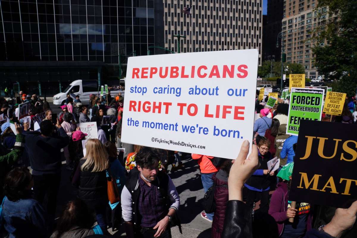 Demonstrators hold signs during a rally to defend abortion access and codify Roe v Wade into law, in Foley Square in New York City on October 8, 2022.