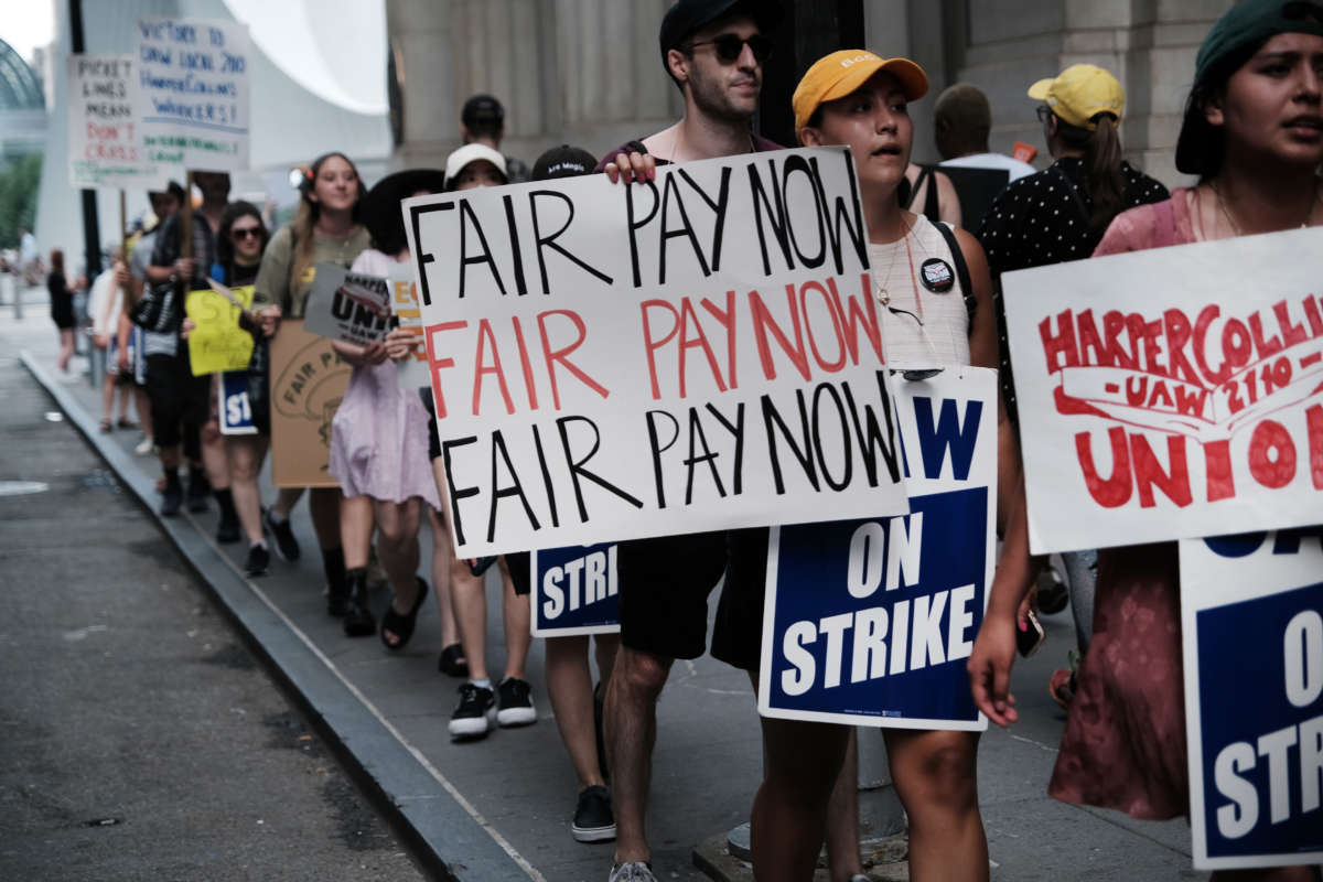 Employees of HarperCollins Publisher participate in a one-day strike outside the publishing houses offices in Manhattan on July 20, 2022, in New York City.