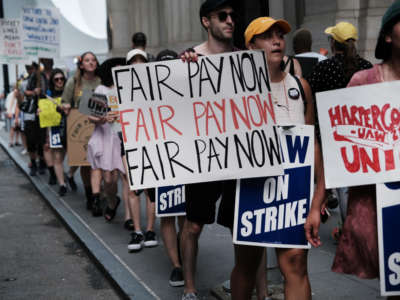 Employees of HarperCollins Publisher participate in a one-day strike outside the publishing houses offices in Manhattan on July 20, 2022, in New York City.