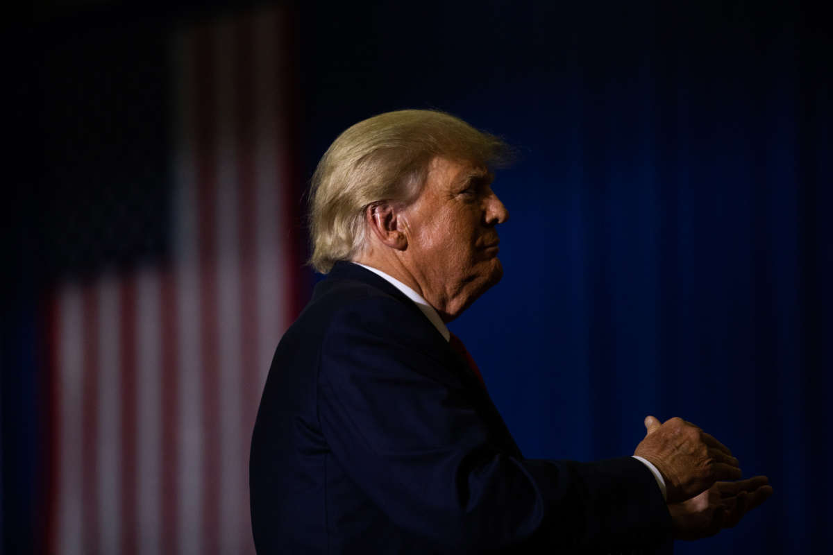 Former President Donald Trump claps during a rally on October 1, 2022, in Warren, Michigan.