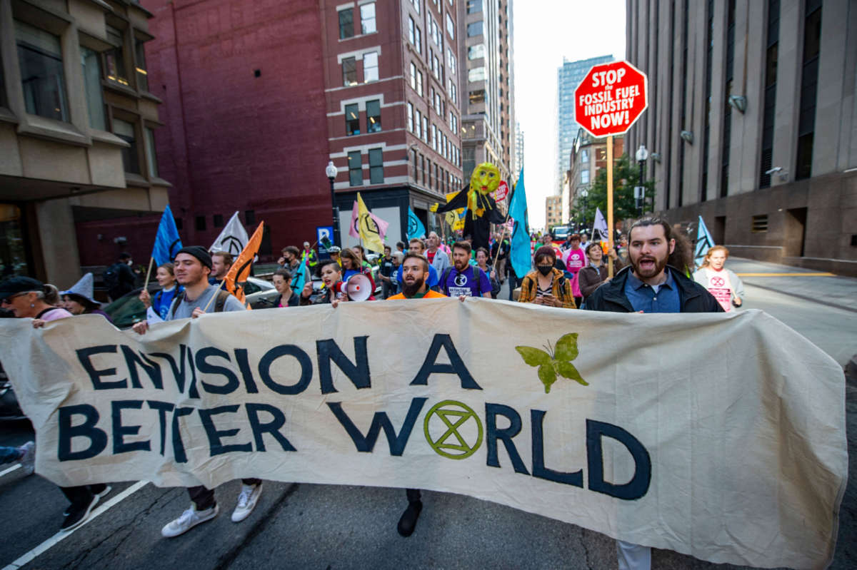 Climate activists from the group Extinction Rebellion march through the streets after blockading several roads in Boston, Massachusetts, on September 21, 2022.