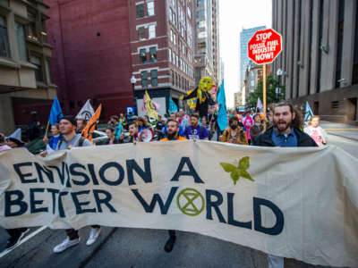 Climate activists from the group Extinction Rebellion march through the streets after blockading several roads in Boston, Massachusetts, on September 21, 2022.