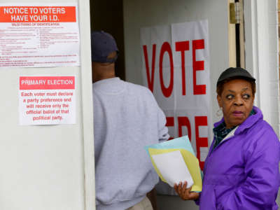 Two voters wait in line at the Rangedale Community Building during the presidential primary in Selma, Alabama, on March 3, 2020.
