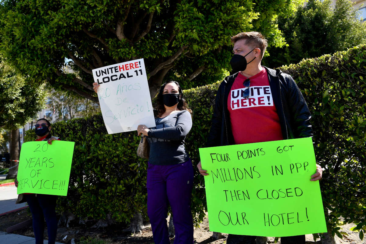 Laid-off employees and workers with Unite Here 11 protest outside the closed Four Points by Sheraton LAX hotel as they call for an investigation into the use of Paycheck Protection Program (PPP) loan funds on April 7, 2021, in Los Angeles, California.