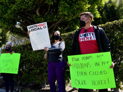 Laid-off employees and workers with Unite Here 11 protest outside the closed Four Points by Sheraton LAX hotel as they call for an investigation into the use of Paycheck Protection Program (PPP) loan funds on April 7, 2021, in Los Angeles, California.