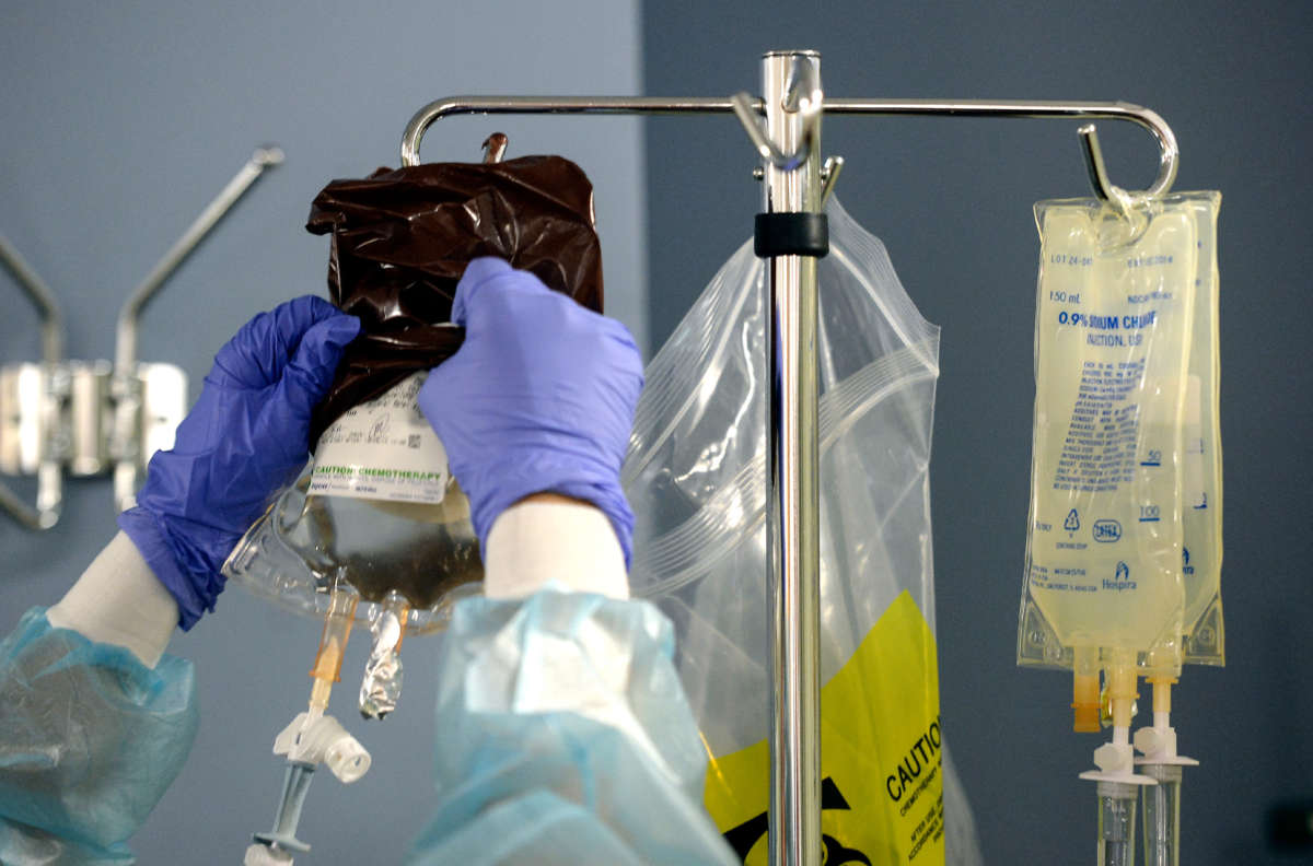 A nurse hangs medicine as a patient goes through his fifth and final round of chemotherapy at MedStar Georgetown University Hospital on October 17, 2013.