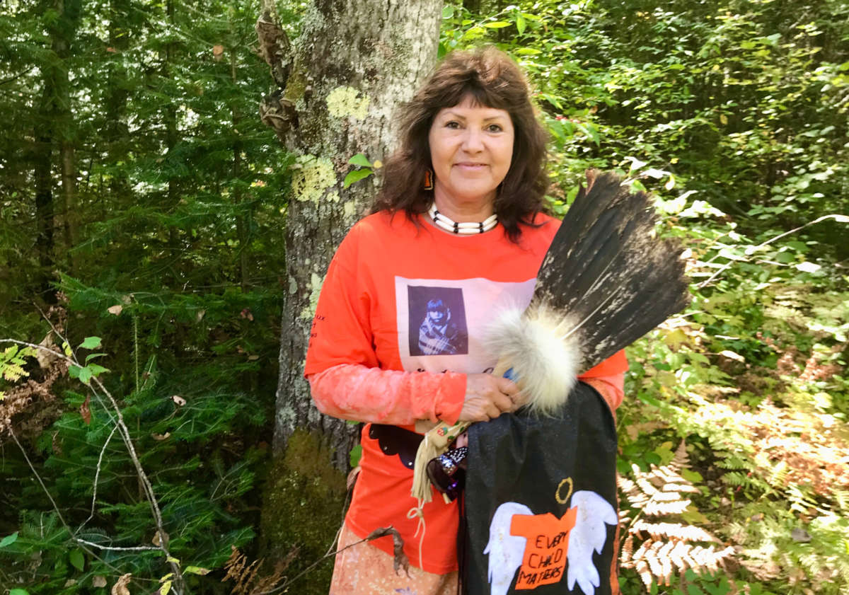 Linda Raye Cobe at the edge of the woods at her childhood home in Watersmeet, Michigan, where she used to run "free as a bird" before being taken to Indian boarding school in Harbor Springs, more than five hours away from her parents, when she was only 5 years old.