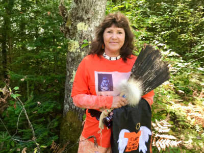 Linda Raye Cobe at the edge of the woods at her childhood home in Watersmeet, Michigan, where she used to run "free as a bird" before being taken to Indian boarding school in Harbor Springs, more than five hours away from her parents, when she was only 5 years old.