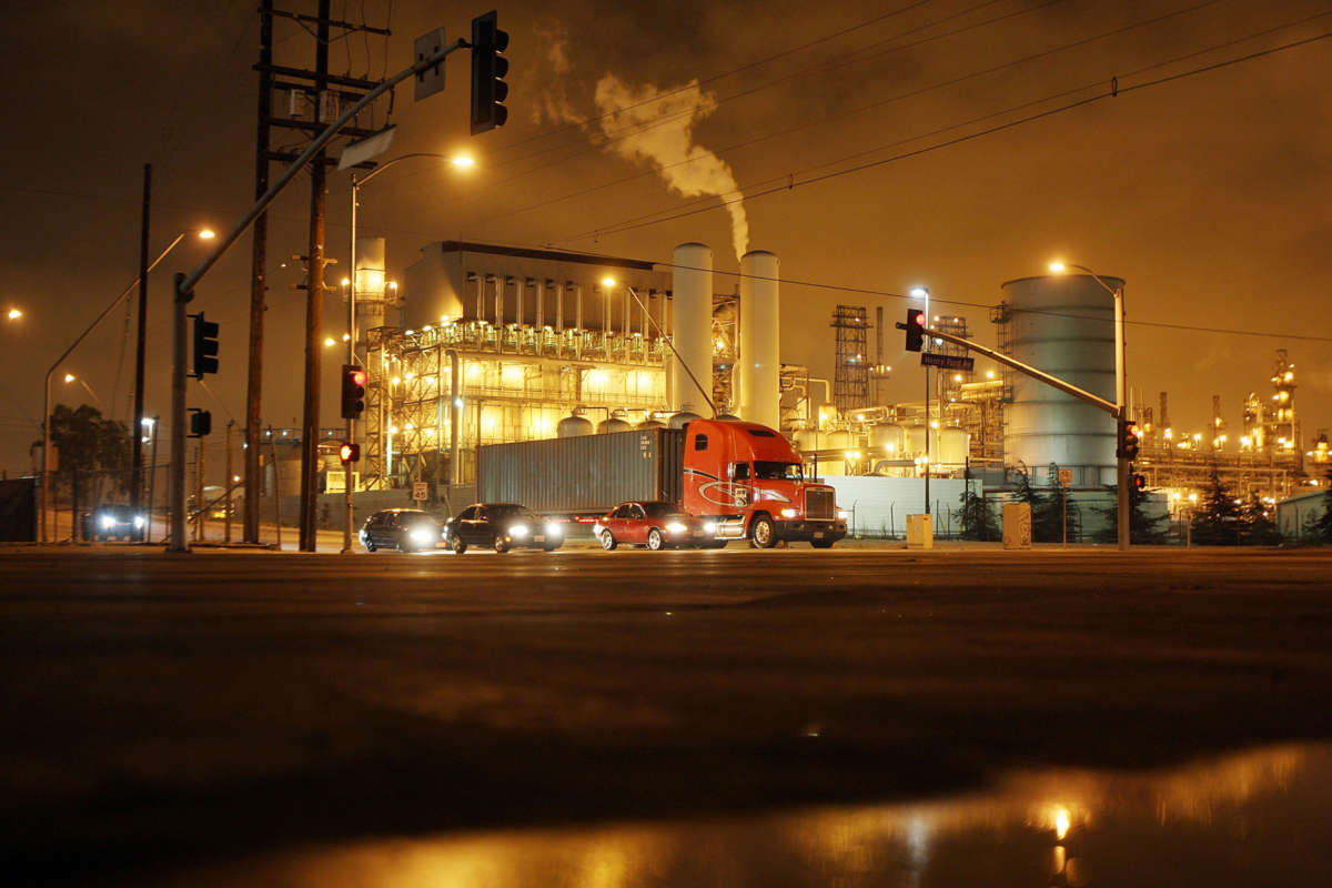 A truck drives past a power plant