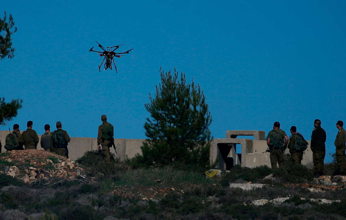 Israeli soldiers look at a drone prepared to throw gas canisters during clashes with Palestinian protestors in Ramallah, near the Jewish settlement of Beit El, in the occupied West Bank on December 14, 2018.