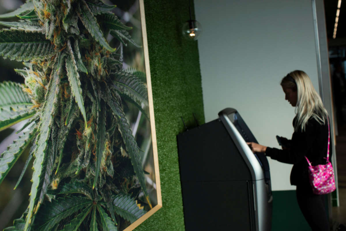 A customer uses an ATM at a medical marijuana dispensary on April 21, 2022, in Bloomfield, New Jersey.