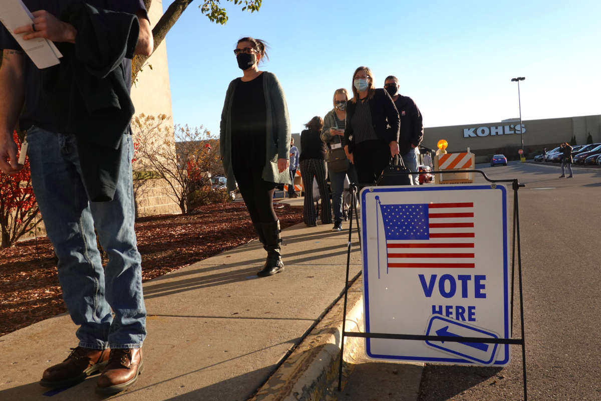 Residents wait in line to vote at a shuttered Sears store in the Janesville Mall on November 3, 2020, in Janesville, Wisconsin.