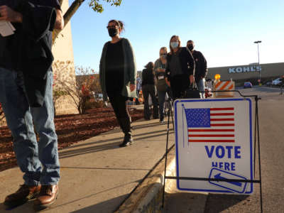 Residents wait in line to vote at a shuttered Sears store in the Janesville Mall on November 3, 2020, in Janesville, Wisconsin.