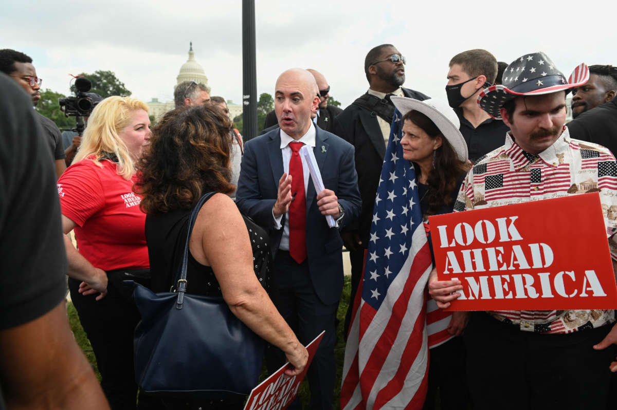 Matt Braynard, center, the rally organizer and executive director of Look Ahead America, speaks to a supporter as demonstrators gather for the "Justice for J6" rally in Washington, D.C., on September 18, 2021, in support of the pro-Trump rioters who ransacked the U.S. Capitol on January 6, 2021.