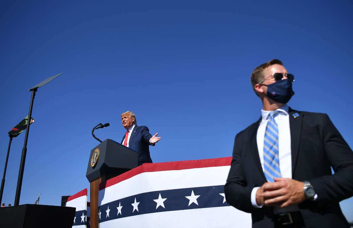 A U.S. secret service agent stands guard as then-President Donald Trump speaks during a rally at Prescott Regional Airport in Prescott, Arizona, on October 19, 2020.