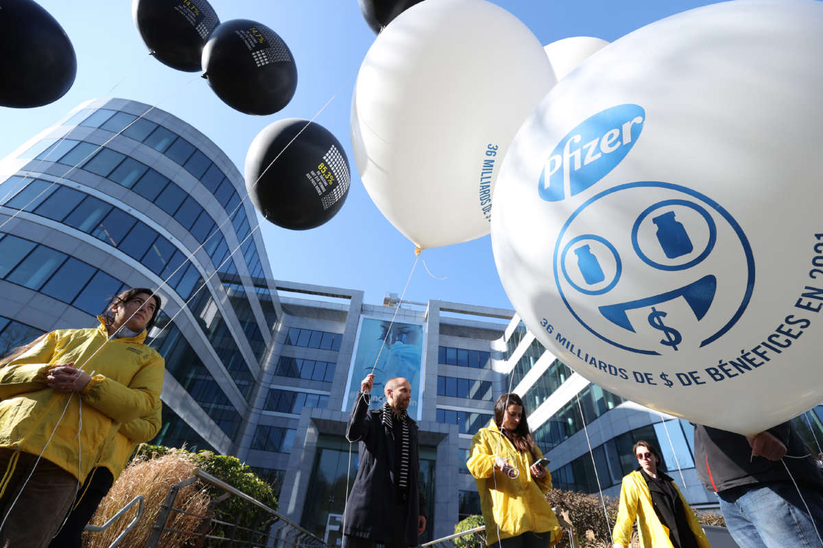 Members of Amnesty International stage a demonstration with balloons demanding more vaccines to be sent to poor countries in front of Pfizer's headquarters in Brussels, Belgium, on March 11, 2022.