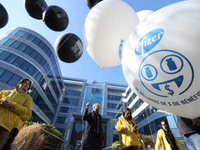 Members of Amnesty International stage a demonstration with balloons demanding more vaccines to be sent to poor countries in front of Pfizer's headquarters in Brussels, Belgium, on March 11, 2022.