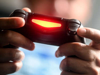 A young man plays with a Playstation 4 game console in Berlin, Germany, on April 2, 2020.