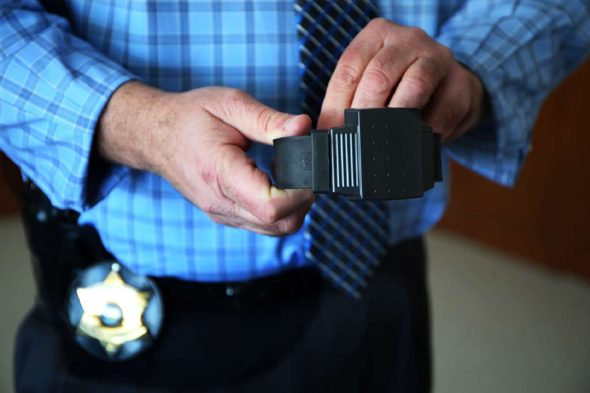 Gregory Shields, director of the Cook County sheriff's electronic monitoring program, shows an electronic ankle bracelet on February 5, 2015.