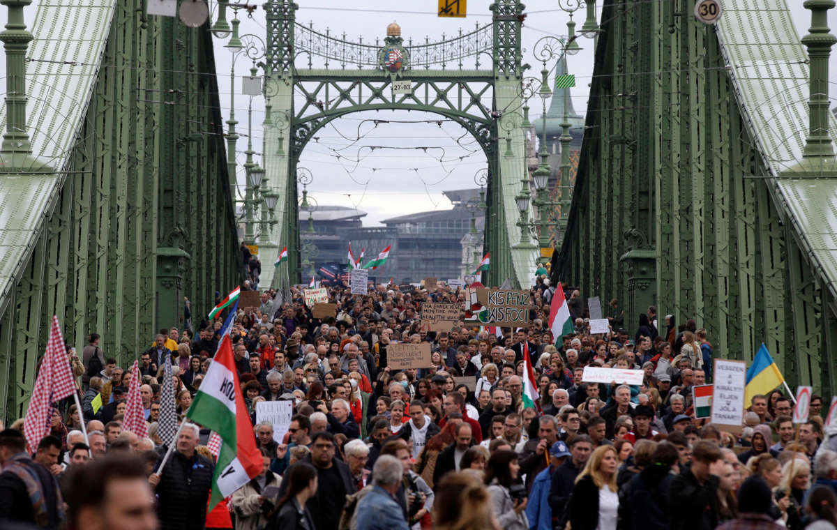 People demonstrate during a protest of teachers and students against the government's education policy and for better working conditions on October 23, 2022, on a bridge in Budapest, Hungary.