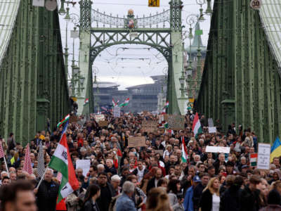 People demonstrate during a protest of teachers and students against the government's education policy and for better working conditions on October 23, 2022, on a bridge in Budapest, Hungary.