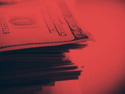 Stack of hundred dollar bills with red overlay