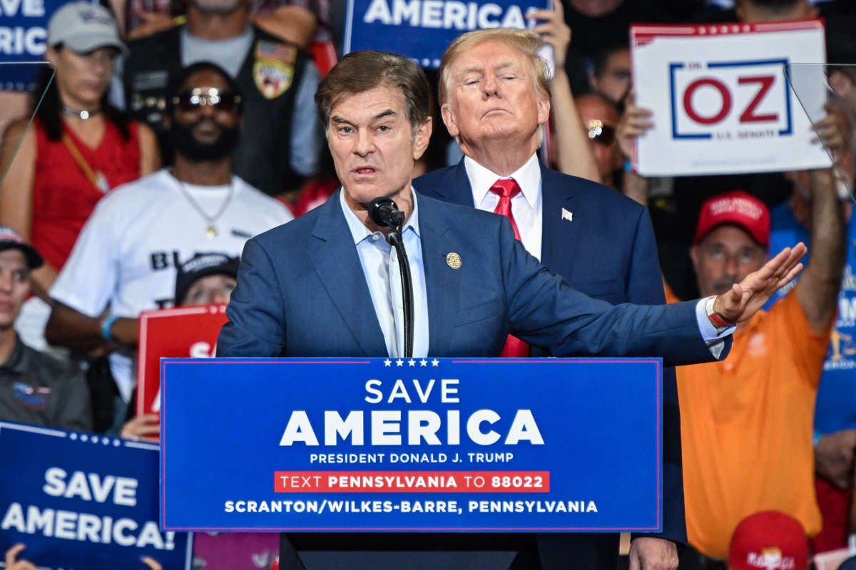 Mehmet Oz, who is running for the U.S. Senate, speaks as former President Donald Trump stands behind him during a campaign rally at Mohegan Sun Arena in Wilkes-Barre, Pennsylvania, on September 3, 2022.