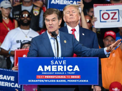 Mehmet Oz, who is running for the U.S. Senate, speaks as former President Donald Trump stands behind him during a campaign rally at Mohegan Sun Arena in Wilkes-Barre, Pennsylvania, on September 3, 2022.