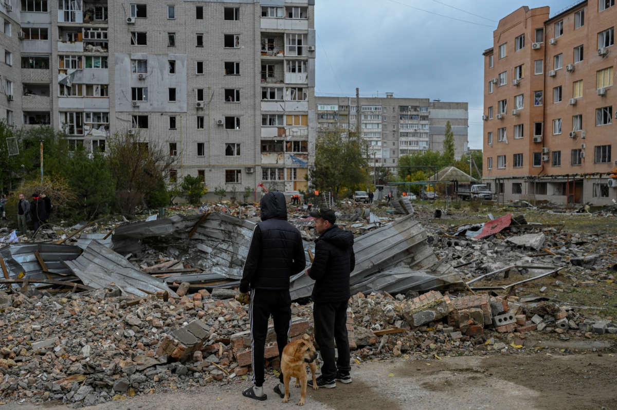 People look at the damages after a rocket attack in Mykolaiv on October 23, 2022, amid the Russian invasion in Ukraine.