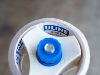 Close-up of logo for shipping and logistics supply company Uline on packing tape dispenser