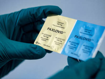 A person holds the COVID-19 drug Paxlovid from the pharmaceutical company Pfizer.