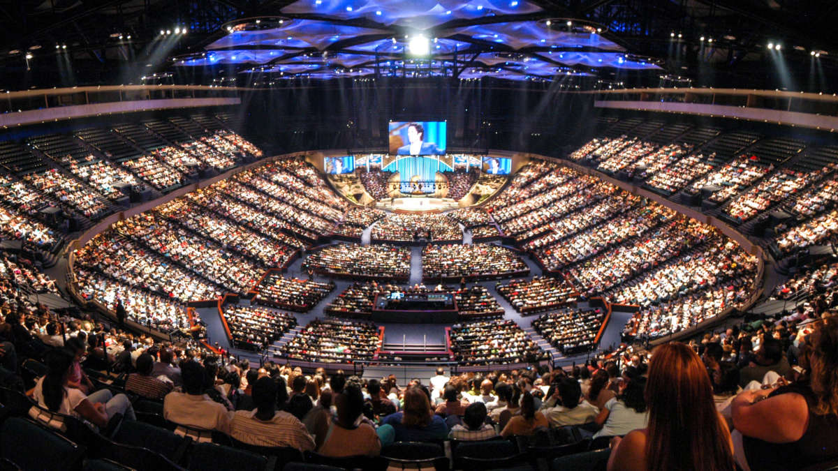 A full audience in a large mega church auditorium