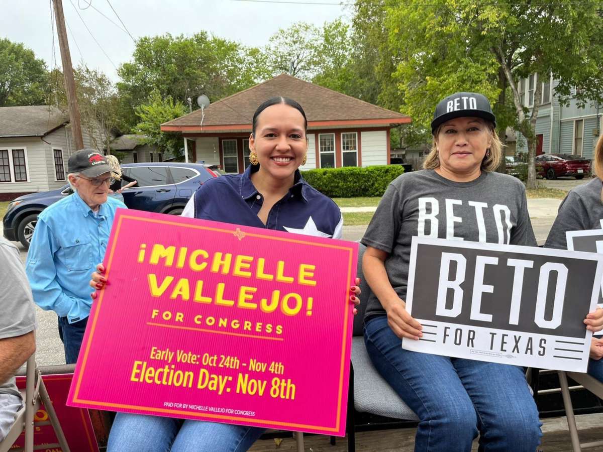 Michelle Vallejo holds a campaign sign during an event